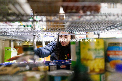Bree Bell, a freshman from Omaha, sorts boxes of food at Matt Talbot Tuesday morning. Nebraska Unive