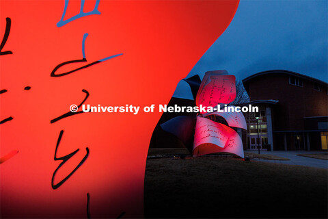 Close up of the Torn Notebook sculpture lit up red for Glow Big Red. February 15, 2023. 