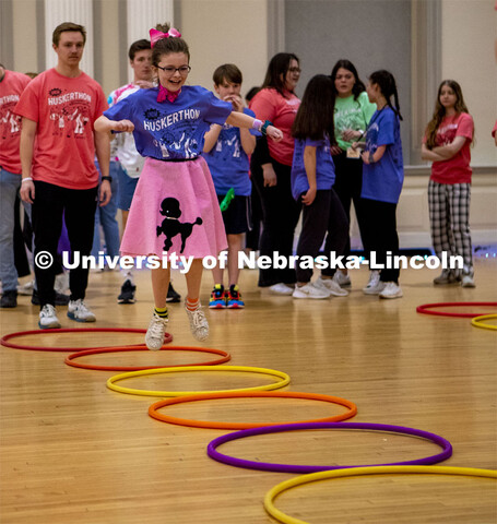 Parker Matzen hops through hulahoops at the 2023 HuskerThon. University of Nebraska–Lincoln studen