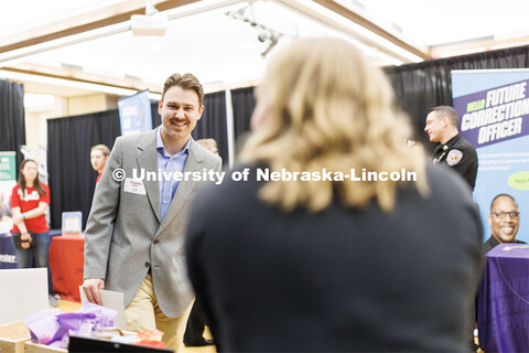 Clayton Meder talks with a recruiter at the Career and Internship Fair in Nebraska Union. February 2