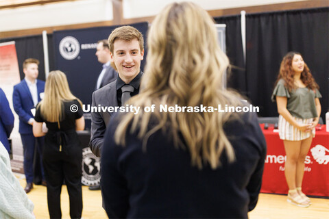 Tyler Mulliken talks with a recruiter from First Nebraska Bank at the Career and Internship Fair in 