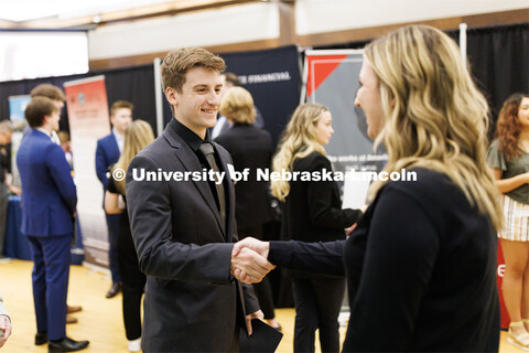 Tyler Mulliken talks with a recruiter from First Nebraska Bank at the Career and Internship Fair in 