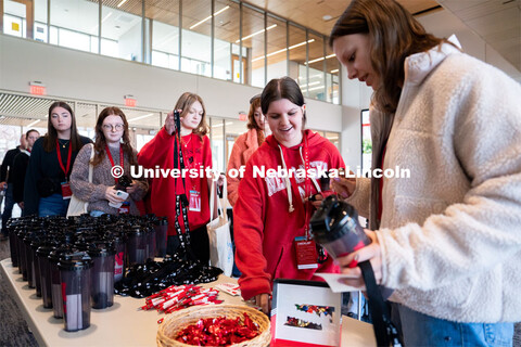 New students grab water bottles and stickers during Admitted Student Day inside Carolyn Pope Edwards