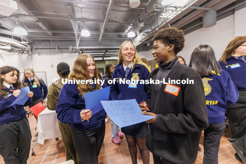 Jacie Bonneau and Kirsten Frey from Pender FFA talk with Ahmed Babiker from Lincoln Northeast FFA as