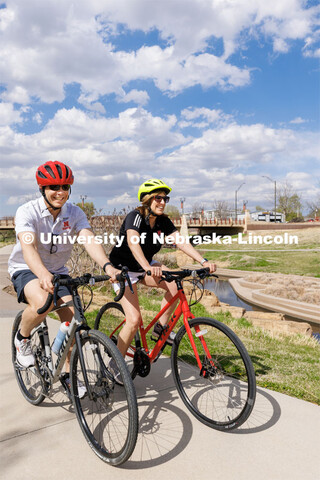 College of Business Dean Kathy Farrell rides bicycles with her husband, Sam, capped by coffee at a l