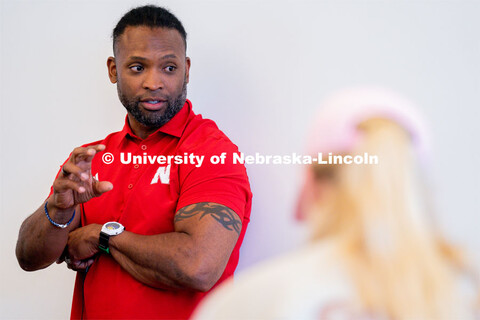 Ahman Green talks to students as they plan an esports event during his Intro to Esports class in And