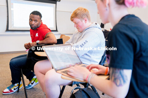 Ahman Green listens as students plan an esports event during his Intro to Esports class in Andersen 