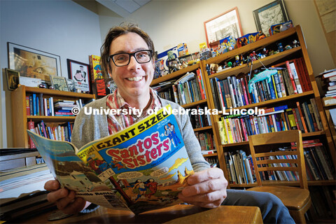 Richard Graham, Associate Professor of University Libraries, sits in his office overflowing with com