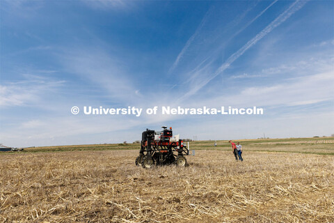 Graduate student Ian Tempelmeyer, red shirt, and graduate research assistant Taylor Cross walk behin