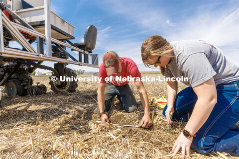 Graduate student Ian Tempelmeyer, left, and graduate research assistant Taylor Cross dig through the