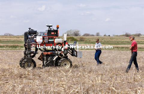 Graduate student Ian Tempelmeyer, right, and graduate research assistant Taylor Cross walk behind th