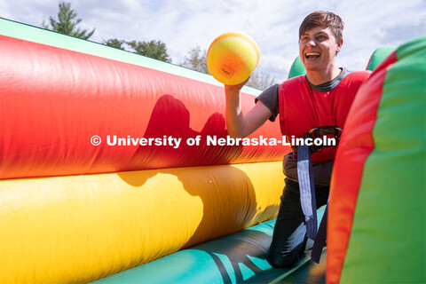 Sophomore Broadcasting major Ian Vondrak laughs as he grabs a ball at the 2023 End of Year Bash at E