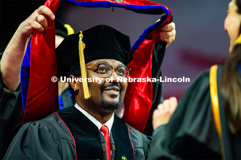 Grad being hooded at the 2023 Spring Graduate Commencement in Bob Devaney Sports Center. May 19, 202