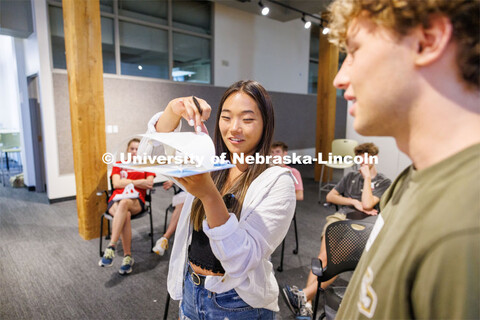 Mattie Purcell, a 2023 architecture graduate who is helping with the summer workshop, critiques one 