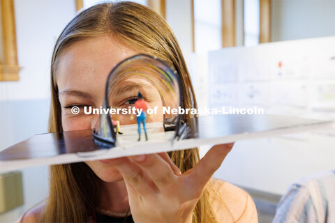 Tatem Moore, a high school student from Wyoming, looks through the project her team designed for an 