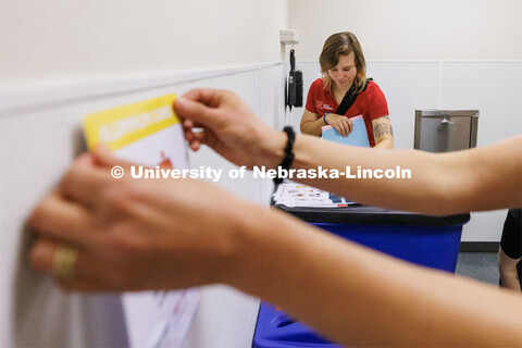 Anna Oetting sorts labels for a trash room in the Suites. Office of Sustainability is finishing thei