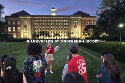 Emmerson Putnam tells a group of students about Love Library, its accompanying gardens, and the Dunk