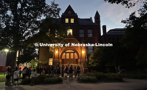 A group of students gathers at Architecture Hall to learn some of the history of the oldest building