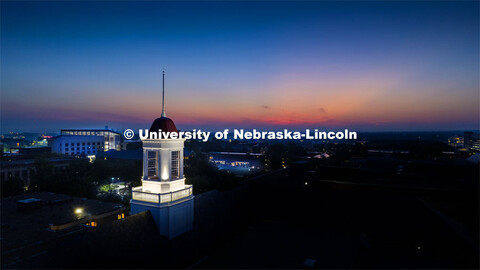 The cupola on Love Library glows at dawn as the sun rises on the First day of classes of fall semest