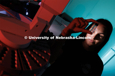 Anastasia Spruce looks through a vial for a gas chromatography mass spectrometer in Filley Hall. Spr