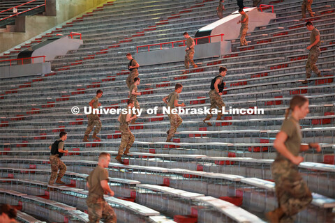Army ROTC cadets spring up the steps in Memorial Stadium. ROTC cadets and midshipmen run 110 flights
