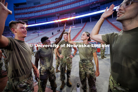 Five Eschleman, left, high fives Malorie Mulligan following their stair climbs. ROTC cadets and mids