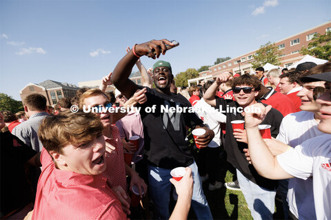 Students dance to the music coming from one of the tents at the Student Tailgate in the greenspace n