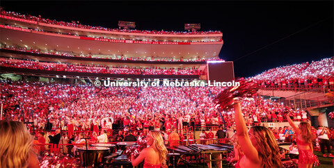 Husker fans light up the night during the light show between the 3rd and 4th quarters. Northern Illi