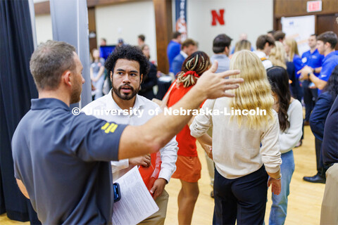 Eldwin Caballero talks with a recruiter for Kiewit at the Career Fair in the Nebraska Union. Septemb