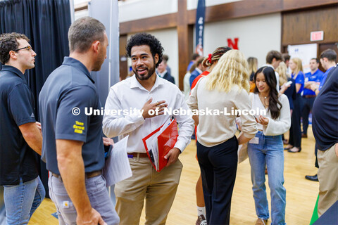 Eldwin Caballero talks with a recruiter for Kiewit at the Career Fair in the Nebraska Union. Septemb