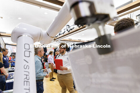 Framed by a robotic arm, Leandro Castellanos Izaguirre, a mechanical engineering and physics major, 