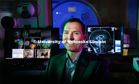 Aron Barbey is backdropped by an fMRI machine at the Center for Brain, Biology and Behavior, which h