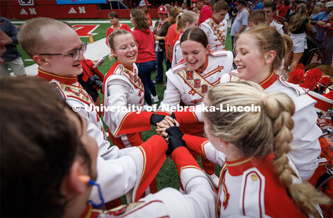 The Husker cymbal line huddles before taking the field for pregame. Nebraska football vs. Louisiana 