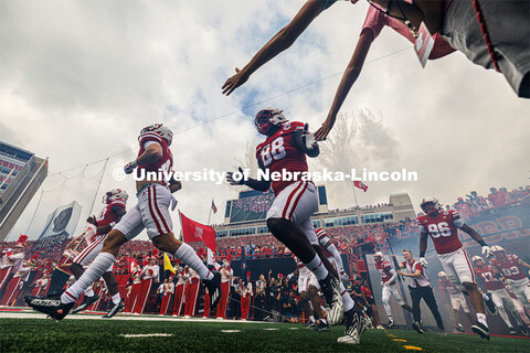 Nebraska football players run on the field through the tunnel walk. Nebraska football vs. Louisiana 