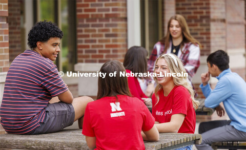 Raikes students hang out at the tables outside of the Kauffman Academic Residential Center. Raikes S