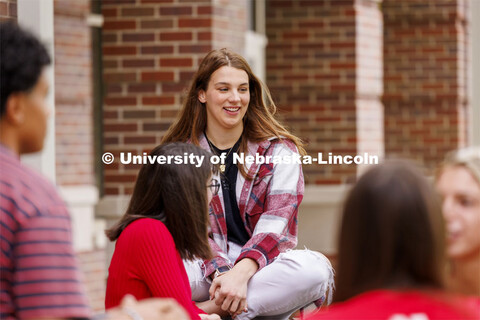 Raikes students hang out at the tables outside of the Kauffman Academic Residential Center. Raikes S