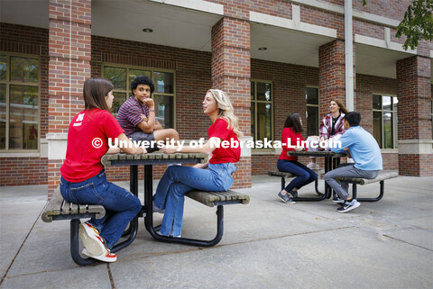 Raikes students hang out at the tables outside of the Kauffman Academic Residential Center. Raikes S