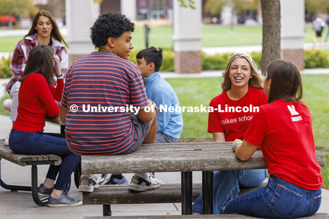 Raikes students hang out at the tables outside of the Kauffman Academic Residential Center. Raikes S