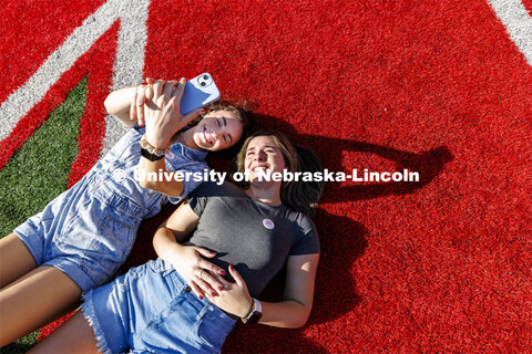 Lydia Storm and Rachel Morros take a selfie on the N in Memorial Stadium during the birthday party. 