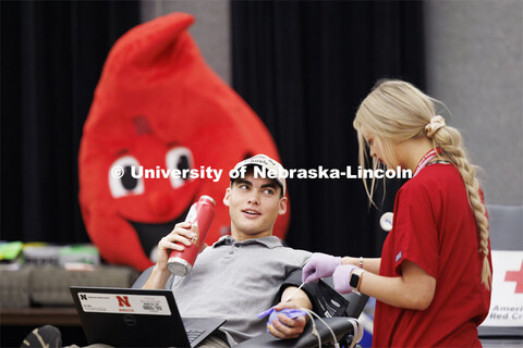 Under the watchful eyes of Buddy the Blood Drop, Caleb Preister, a junior from Lindsay, Nebraska, gi