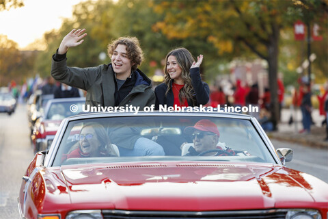 Homecoming royalty candidates Cordell Vrbka and Rachel Morros wave to the crowd along the parade rou