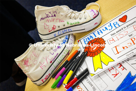 Crandall Blake’s signed and decorated high tops sit on a table next to awards done for her by each