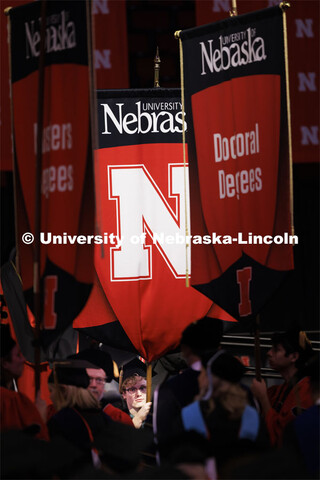 Student body president Paul Pechous holds the gonfalon during the Graduate Commencement at Pinnacle 