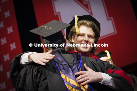 Andrew Loken, hugs Professor Joshua Steelman after Lokens received his doctoral degree in civil engi