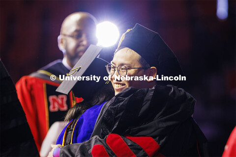 Biquan Zhao hugs one of his advising professors after receiving his doctoral degree in natural resou