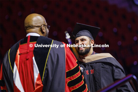 Alex Fernando shakes hands with Chancellor Rodney Bennett after being given his MBA diploma. Graduat