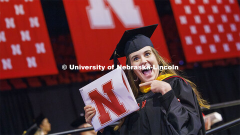 Emily Rowen gestures to family and friends after she received her master’s degree in natural resou