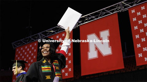 Jaevyn Carson waves to family and friends after receiving her CoJMC diploma. Winter undergraduate co