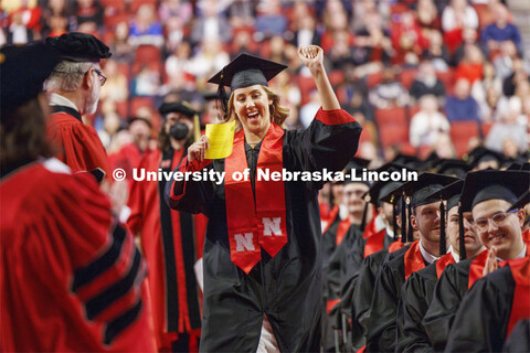 Stella Lepkowski skips down the aisle as she celebrates being the sole candidate for graduation in t