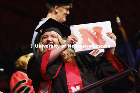 Kayla Klinkacek shows her CEHS diploma to family and friends. Winter undergraduate commencement in P